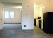 Thumbnail 26 of 40 - A kitchen area with black appliances and white cabinets.
