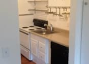 Thumbnail 27 of 40 - A kitchen with white cabinets and a black dishwasher.
