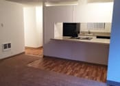 Thumbnail 25 of 40 - A kitchen with white cabinets and a dark countertop.