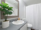 Thumbnail 52 of 64 - A bathroom with a sink, toilet, and a mirror.
