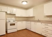 Thumbnail 63 of 64 - A kitchen with white appliances and cabinets.