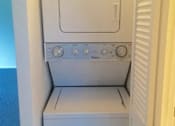 Thumbnail 57 of 64 - A white oven with four knobs is in a room.