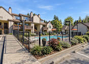 Thumbnail 31 of 56 - A row of houses with a pool in front.