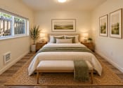 Thumbnail 20 of 56 - A bedroom with a large bed and a painting on the wall.