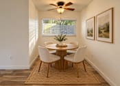 Thumbnail 17 of 56 - A dining room with a round table and chairs.