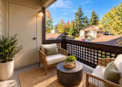 Thumbnail 6 of 56 - A patio with a chair, table and potted plant.