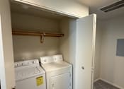 Thumbnail 11 of 18 - A laundry room with a washer and dryer.