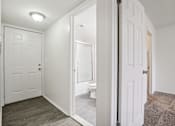 Thumbnail 11 of 12 - A white door is open to a bathroom.
