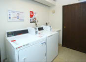 Thumbnail 8 of 8 - a laundry room with two washers and two washing machines