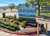 Thumbnail 22 of 22 - A sign for The Grove apartment homes sits in front of a landscaped area.