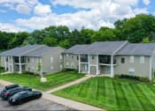 Thumbnail 1 of 8 - an aerial view of an apartment complex with cars parked in front of the lawn