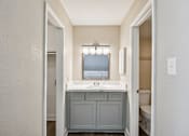 Thumbnail 19 of 27 - A bathroom with a sink and a mirror above it.