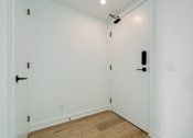 Thumbnail 17 of 81 - A white door with a black handle and a black lock.