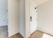 Thumbnail 79 of 81 - A white door with a black handle and a black lock.