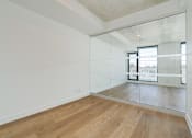 Thumbnail 15 of 81 - A room with wooden floors and a large mirror on the wall.