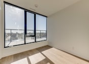 Thumbnail 77 of 81 - A room with a large window and a view of the city.