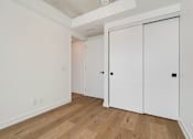 Thumbnail 13 of 81 - A room with a white door and a white wall.