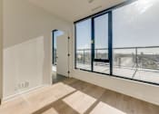 Thumbnail 76 of 81 - A room with a view of the city through large windows.