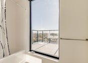 Thumbnail 72 of 81 - A view of a parking lot from a window in a white room.