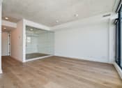 Thumbnail 8 of 81 - A room with wooden flooring and a glass wall.