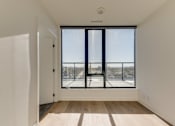 Thumbnail 69 of 81 - A room with a large window overlooking a snowy landscape.