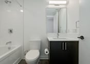 Thumbnail 5 of 81 - A white bathroom with a toilet, sink, and bathtub.