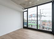 Thumbnail 19 of 81 - A room with a view of the city through large windows.