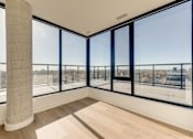 Thumbnail 67 of 81 - A room with a large window overlooking a cityscape.