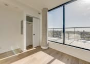 Thumbnail 66 of 81 - A room with a large window overlooking a cityscape.