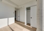 Thumbnail 65 of 81 - A room with white walls and a wooden floor.