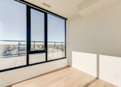 Thumbnail 64 of 81 - A room with a large window overlooking a parking lot.