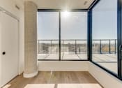 Thumbnail 63 of 81 - A sunny day in a room with a view of a cityscape through large windows.