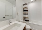 Thumbnail 62 of 81 - A white bathroom with a sink, toilet, and bathtub.