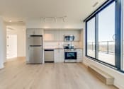 Thumbnail 56 of 81 - A modern kitchen with wooden floors and stainless steel appliances.