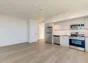 Thumbnail 55 of 81 - A kitchen with white cabinets and stainless steel appliances.