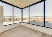 Thumbnail 51 of 81 - A room with a view of the city through large windows.