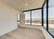 Thumbnail 50 of 81 - A room with a view of a cityscape through large windows.