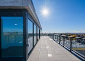 Thumbnail 44 of 81 - A sunny day on a balcony with a view of the city.
