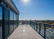 Thumbnail 43 of 81 - A sunny day on a balcony with a view of the city.