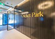 Thumbnail 35 of 81 - A wall with the words Cricket Park written on it.