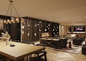 Thumbnail 4 of 11 - A modern dining room with a wooden table and chairs.