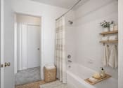 Thumbnail 34 of 36 - A bathroom with a white tub, a white door, and a white wall.