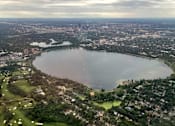 Thumbnail 22 of 58 - A large lake surrounded by a city and a golf course.