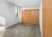Thumbnail 10 of 20 - A room with a tiled floor and a window with blinds.