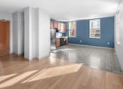 Thumbnail 9 of 20 - A room with a kitchen area and a dining table.