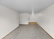 Thumbnail 15 of 39 - A room with white walls and carpeted floor.