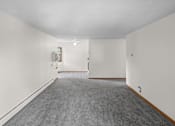 Thumbnail 19 of 39 - A long hallway with a carpeted floor and white walls.
