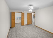 Thumbnail 10 of 59 - A room with carpeted floor and two wooden doors.