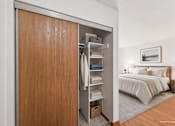 Thumbnail 12 of 39 - A bedroom with a large bed and a wooden wardrobe.