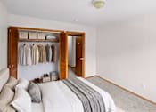 Thumbnail 37 of 39 - A bedroom with a large bed and a wooden wardrobe.